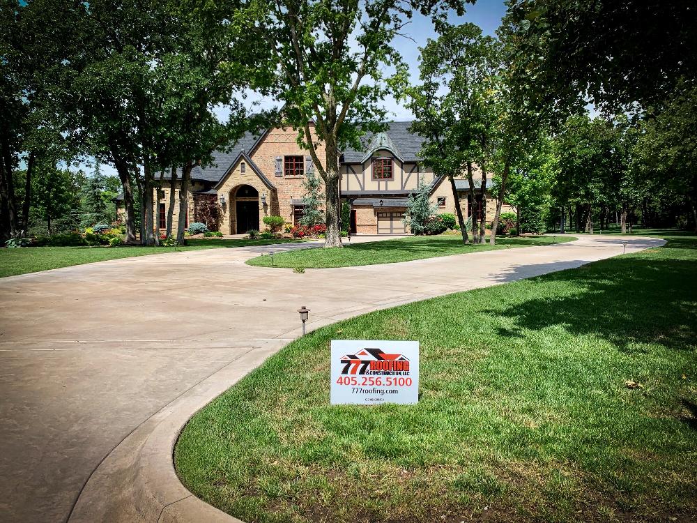 Estate home with 777 Roofing yard sign